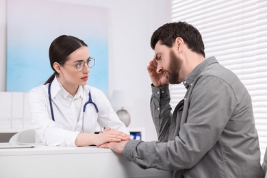 Doctor consulting patient during appointment in clinic