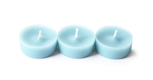 Photo of Light blue wax decorative candles isolated on white