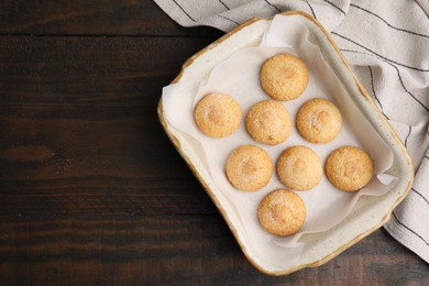 Photo of Tasty sweet sugar cookies in baking dish on wooden table, top view. Space for text