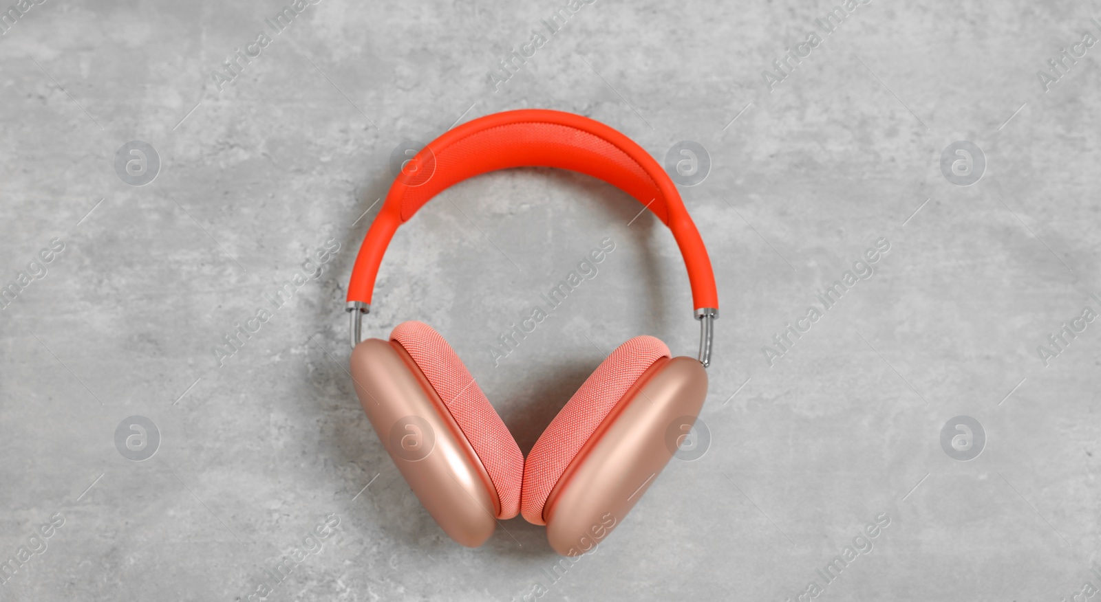 Photo of Stylish pink headphones on light grey table, top view