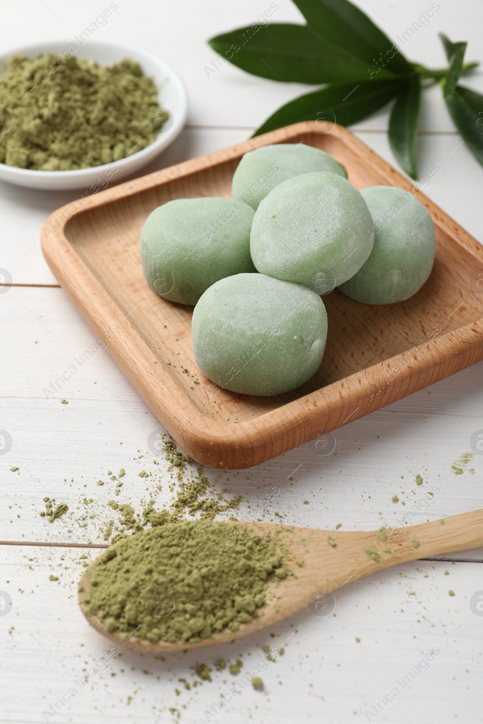 Photo of Delicious matcha mochi on white wooden table