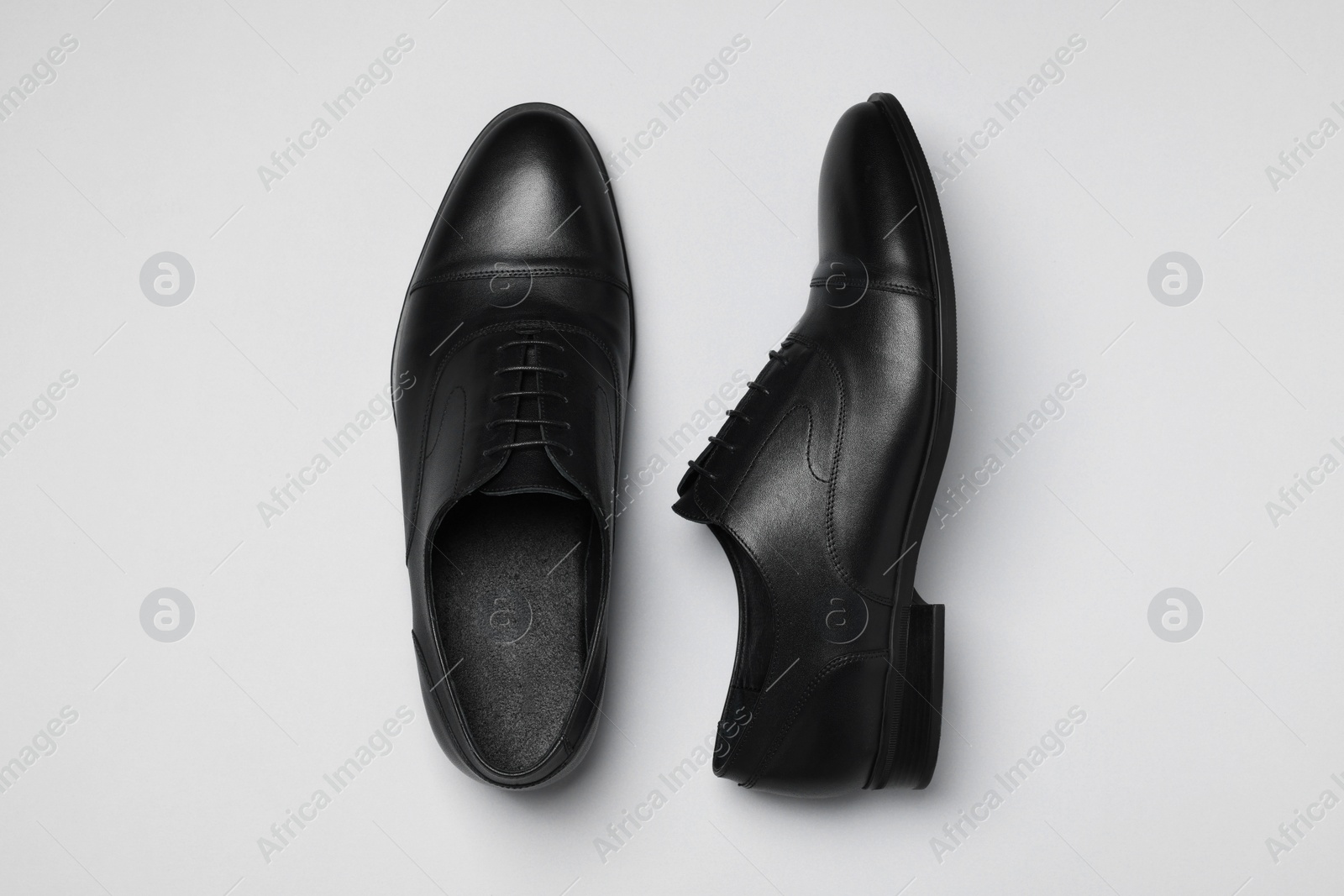 Photo of Pair of leather men shoes on white background, top view