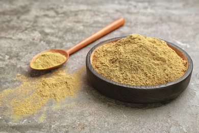 Photo of Dishware and spoon with hemp protein powder on table