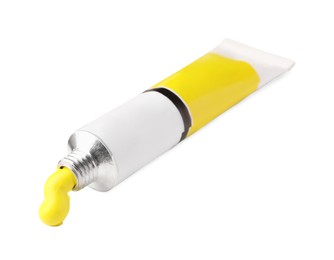 Tube with yellow oil paint on white background