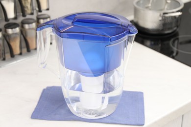 Water filter jug on white countertop in kitchen