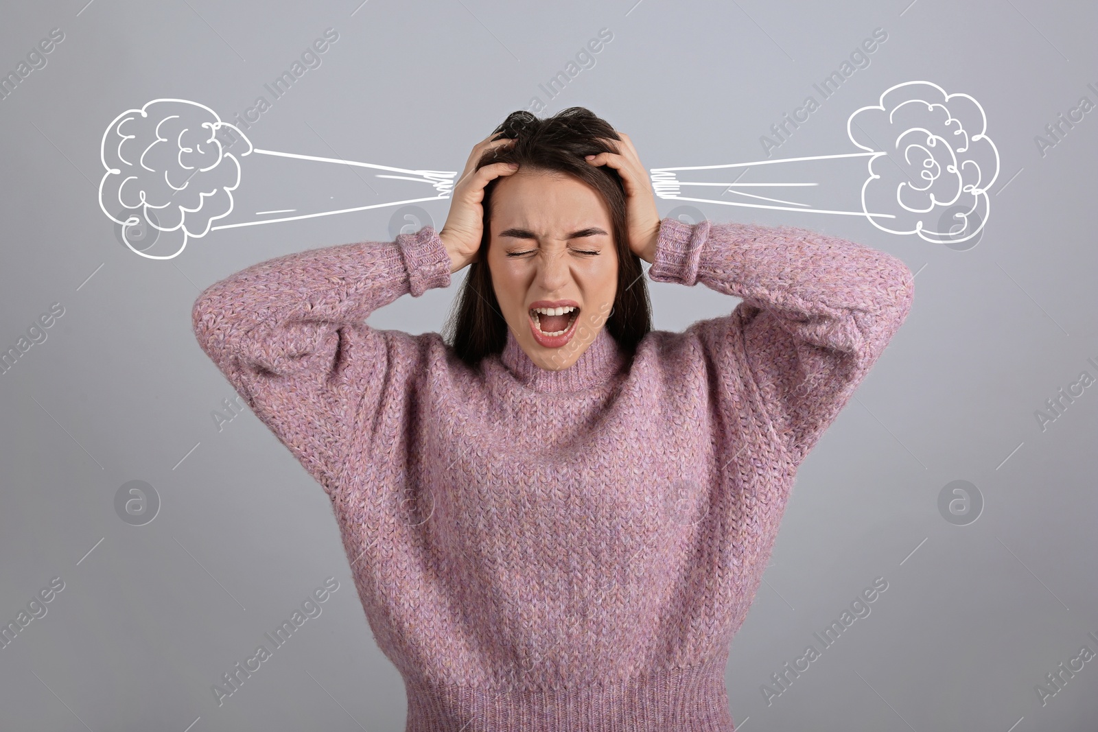 Image of Stressed and upset young woman on light grey background