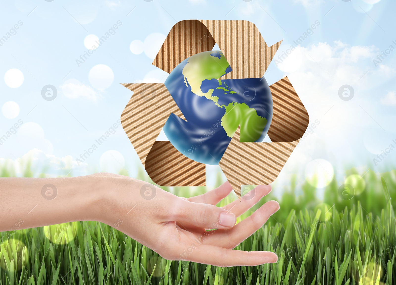 Image of Woman with illustration of Earth and recycling symbol in hand, closeup