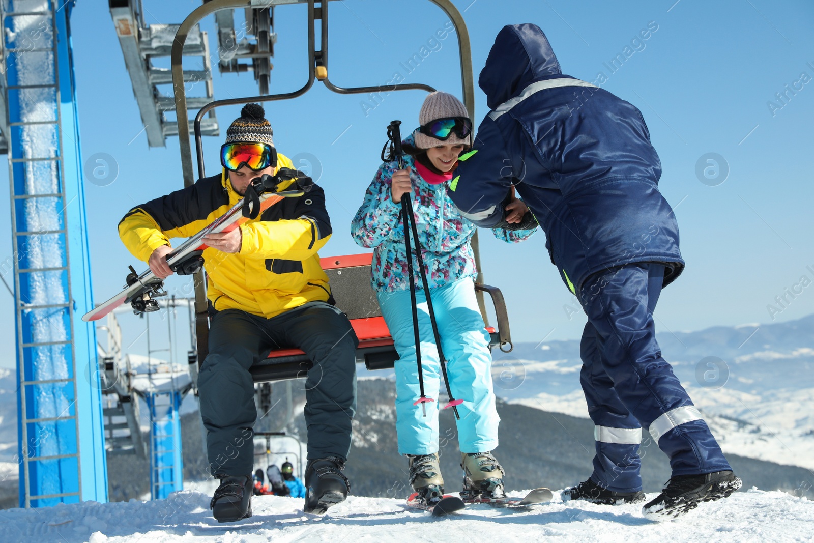 Photo of People using chairlift at mountain ski resort. Winter vacation