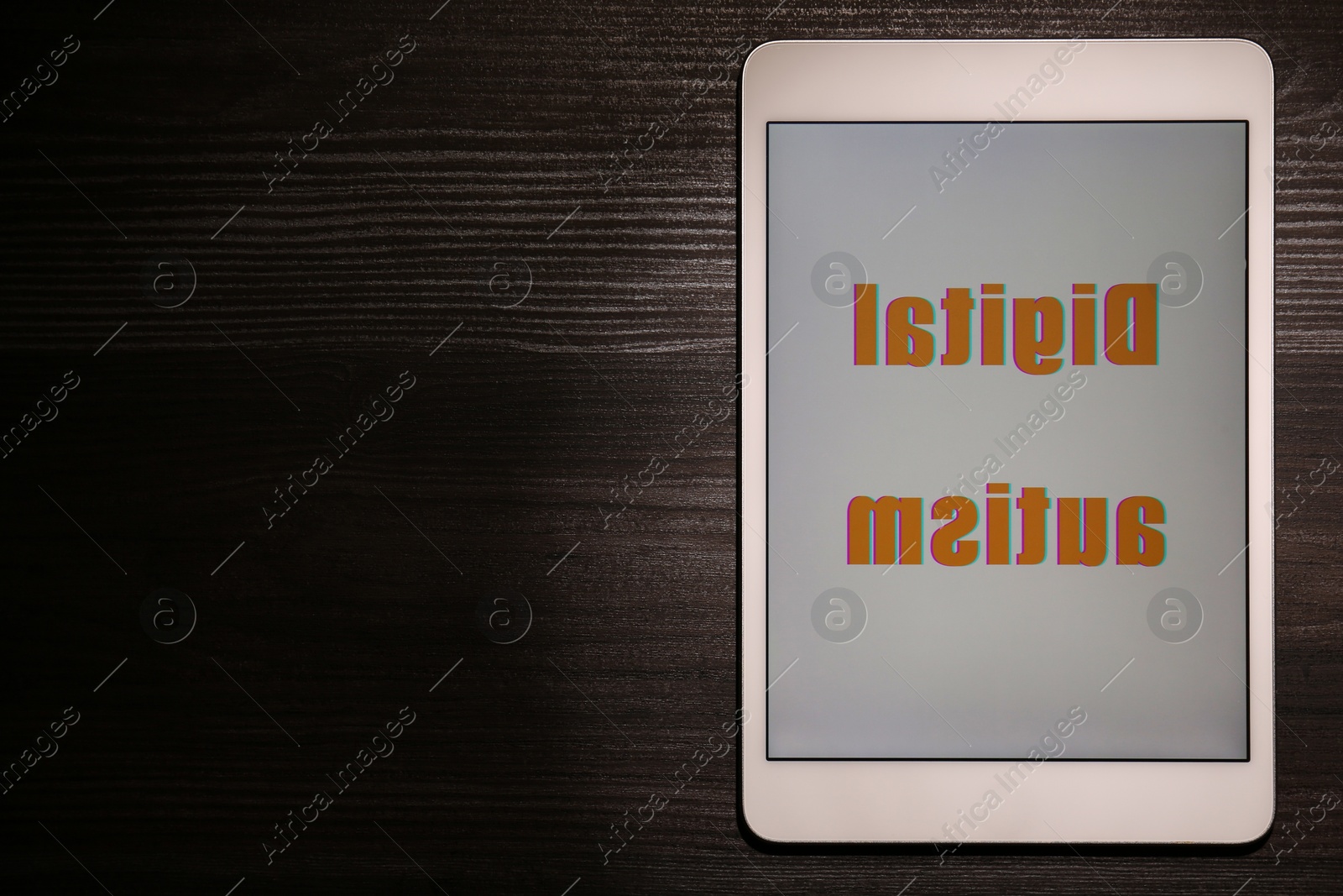 Photo of Tablet with phrase Digital Autism on wooden table, top view and space for text. Addictive behavior