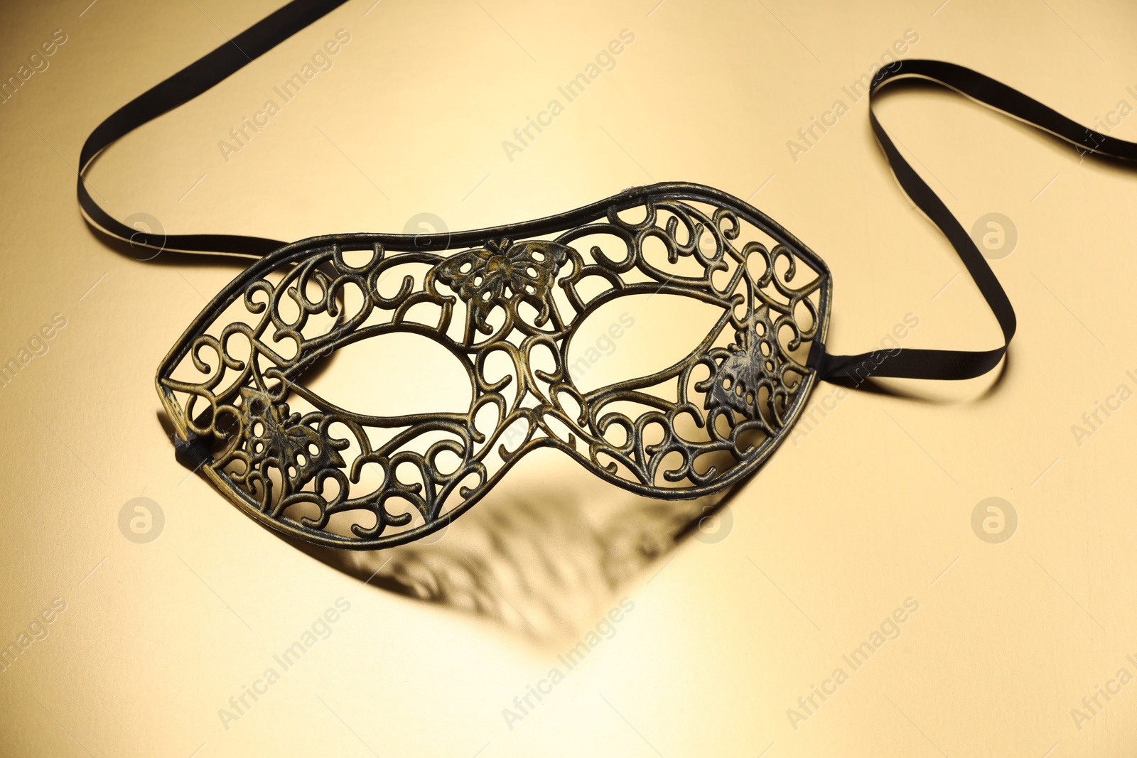 Photo of Elegant face mask on beige background. Theatrical performance
