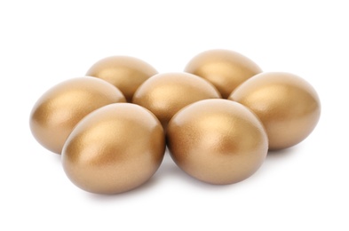 Photo of Many shiny golden eggs on white background