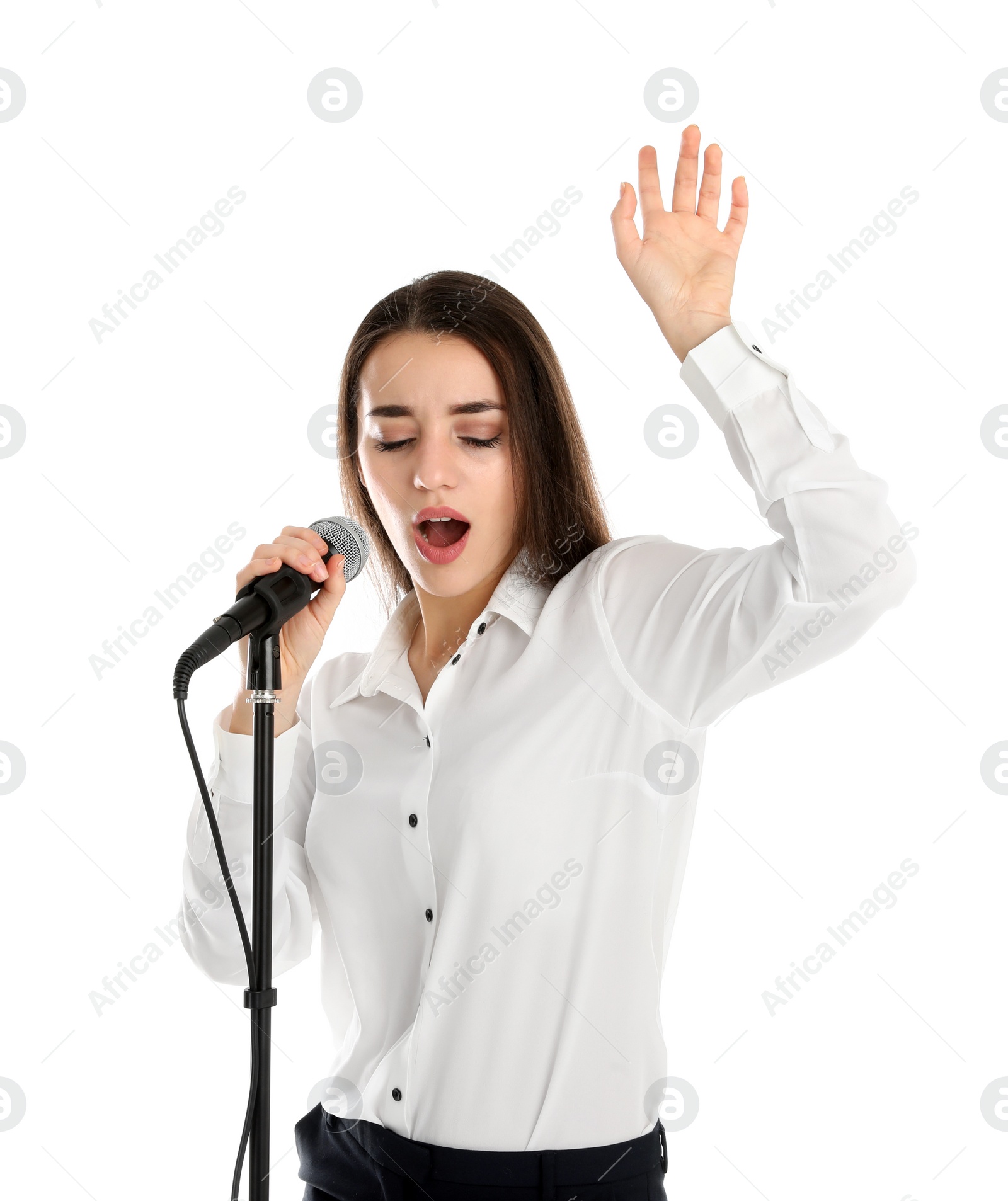 Photo of Young stylish woman singing in microphone on white background