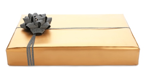 Photo of Golden gift box with black ribbon on white background