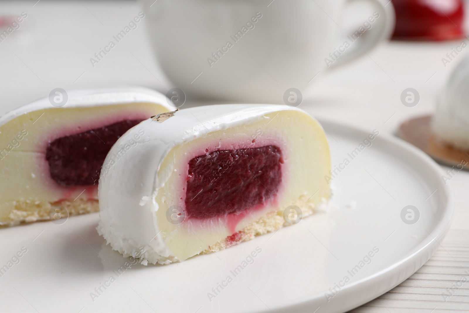 Photo of St. Valentine's Day. Pieces of delicious cake served on white table, closeup