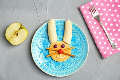 Photo of Flat lay composition with pancake in form of bunny on grey background. Creative breakfast ideas for kids