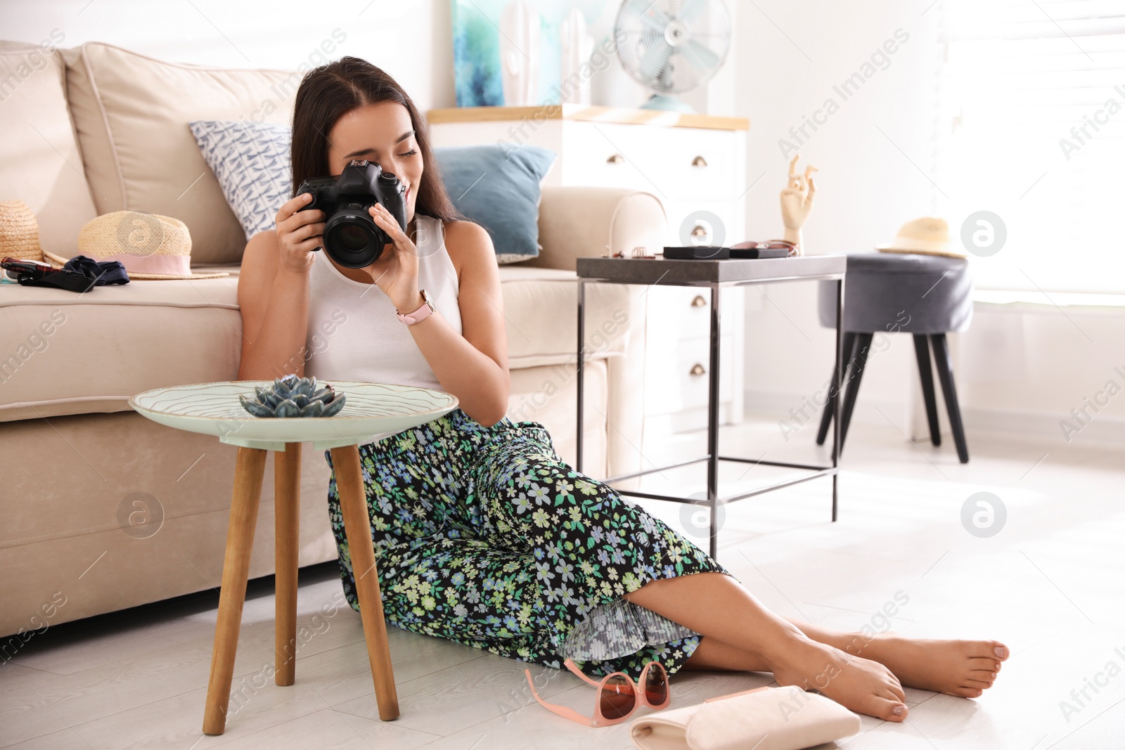 Photo of Young photographer taking picture of jewelry indoors