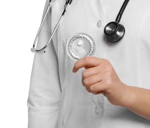 Doctor holding blister of emergency contraception pill on white background, closeup