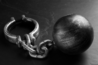 Photo of Prisoner ball with chain on black table