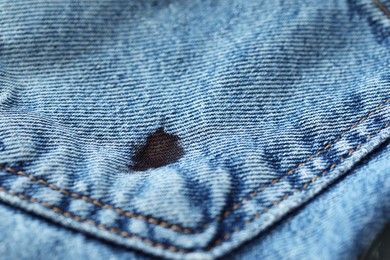 Stain of black ink on jeans, closeup. Space for text