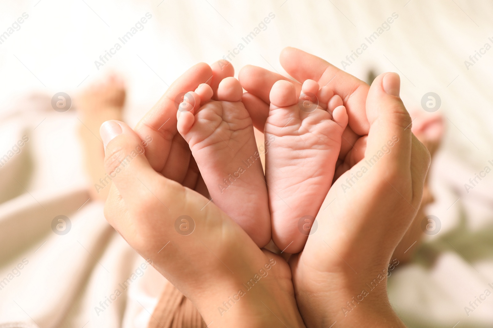 Photo of Mother and her newborn baby on bed, closeup view