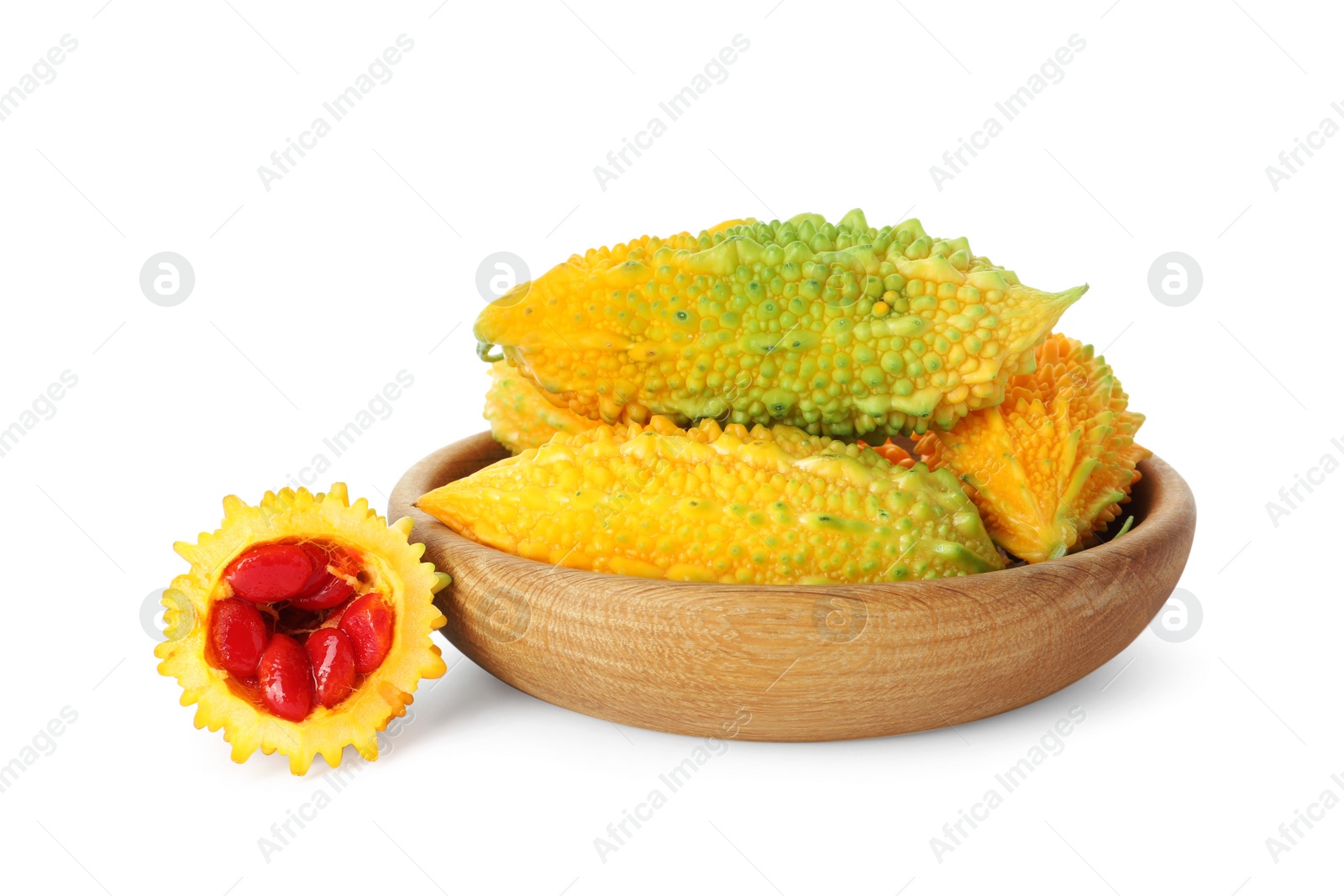 Photo of Wooden bowl with fresh ripe bitter melons on white background