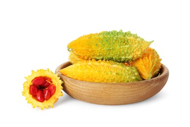 Photo of Wooden bowl with fresh ripe bitter melons on white background