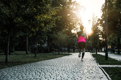 Young woman on morning run in park