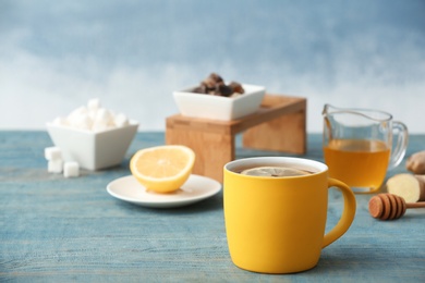 Photo of Hot tea with lemon on table. Space for text