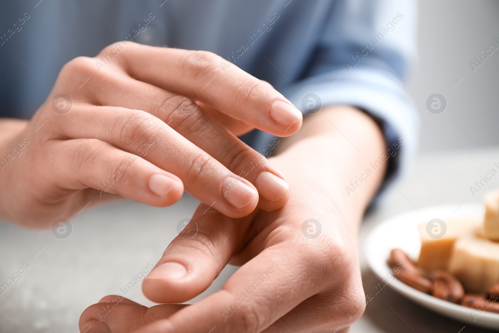 Photo of Woman applying organic cocoa butter at table, closeup