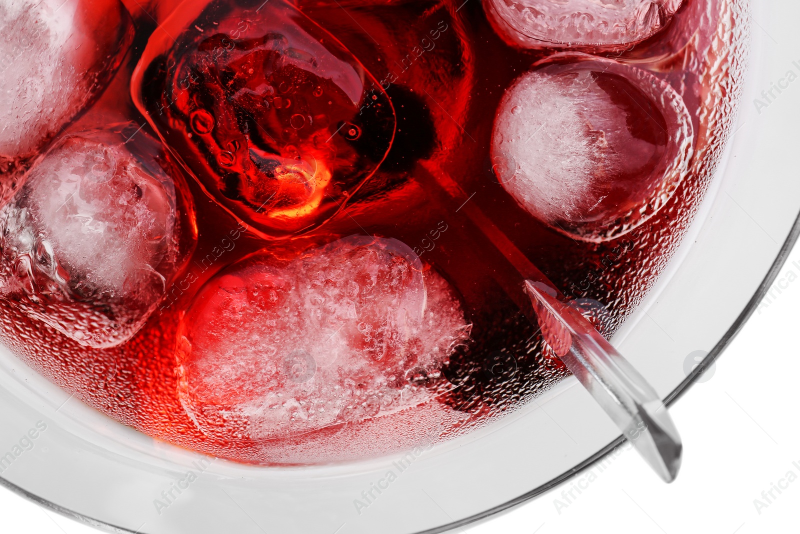 Photo of Glass of martini cocktail with ice cubes on light background, closeup