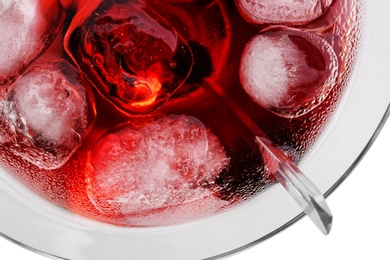 Glass of martini cocktail with ice cubes on light background, closeup