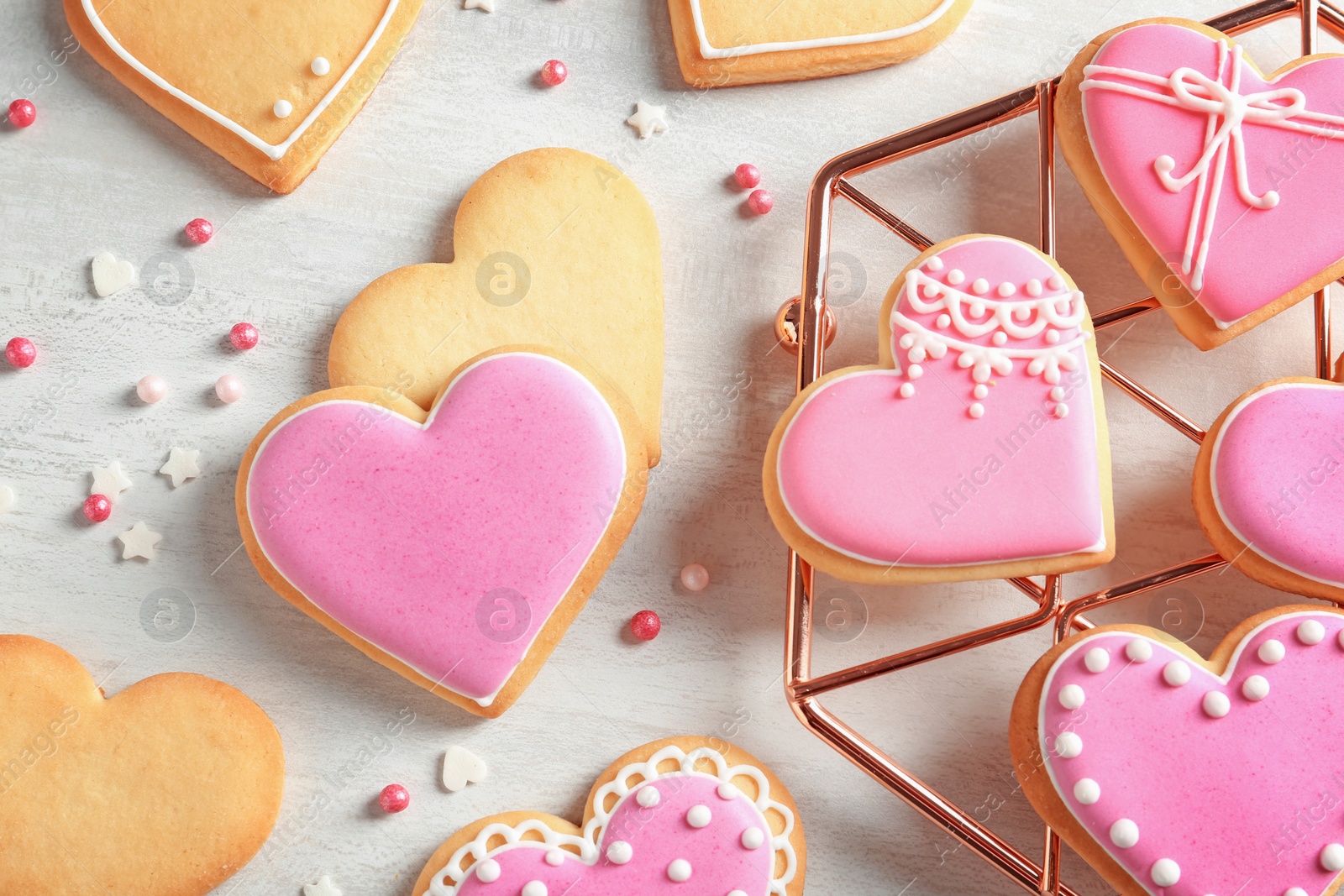 Photo of Flat lay composition with decorated heart shaped cookies on table