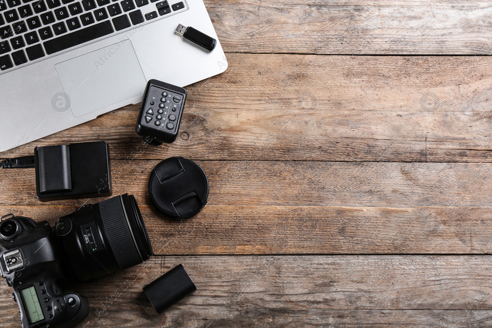 Photo of Flat lay composition with equipment for professional photographer on wooden table. Space for text