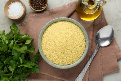 Raw couscous and ingredients on light table, flat lay