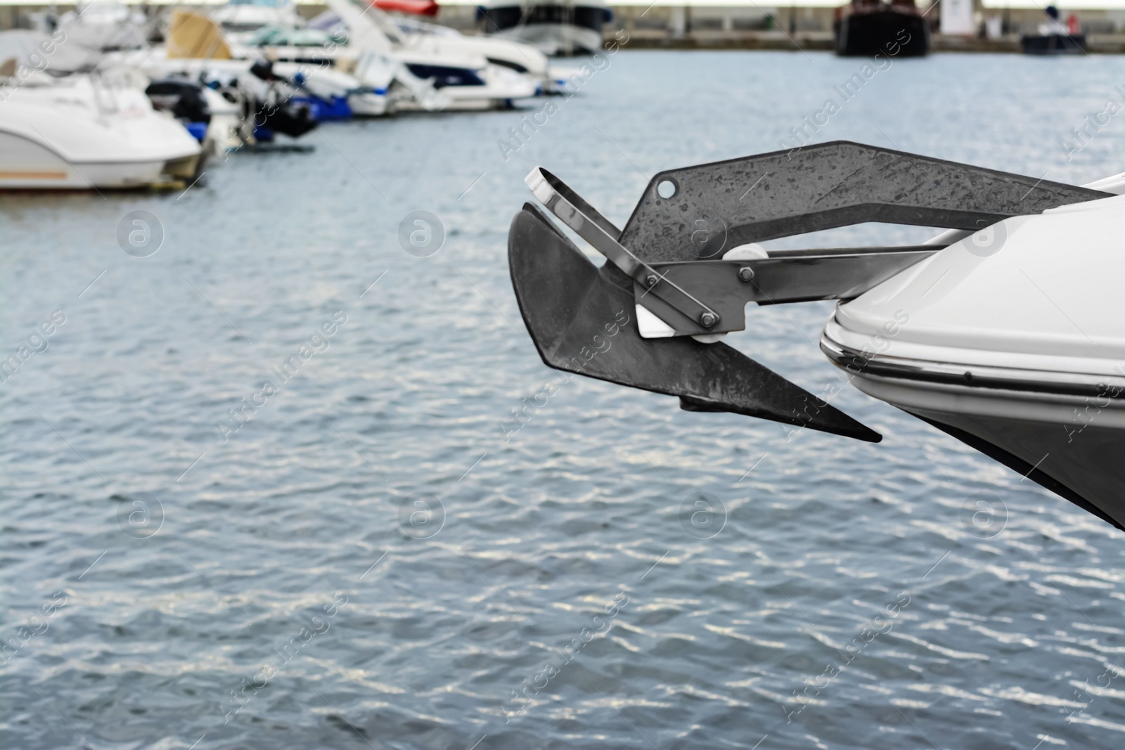 Photo of Huge and massive anchor of modern yacht moored in harbor near sea