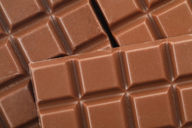 Delicious milk chocolate as background, closeup view