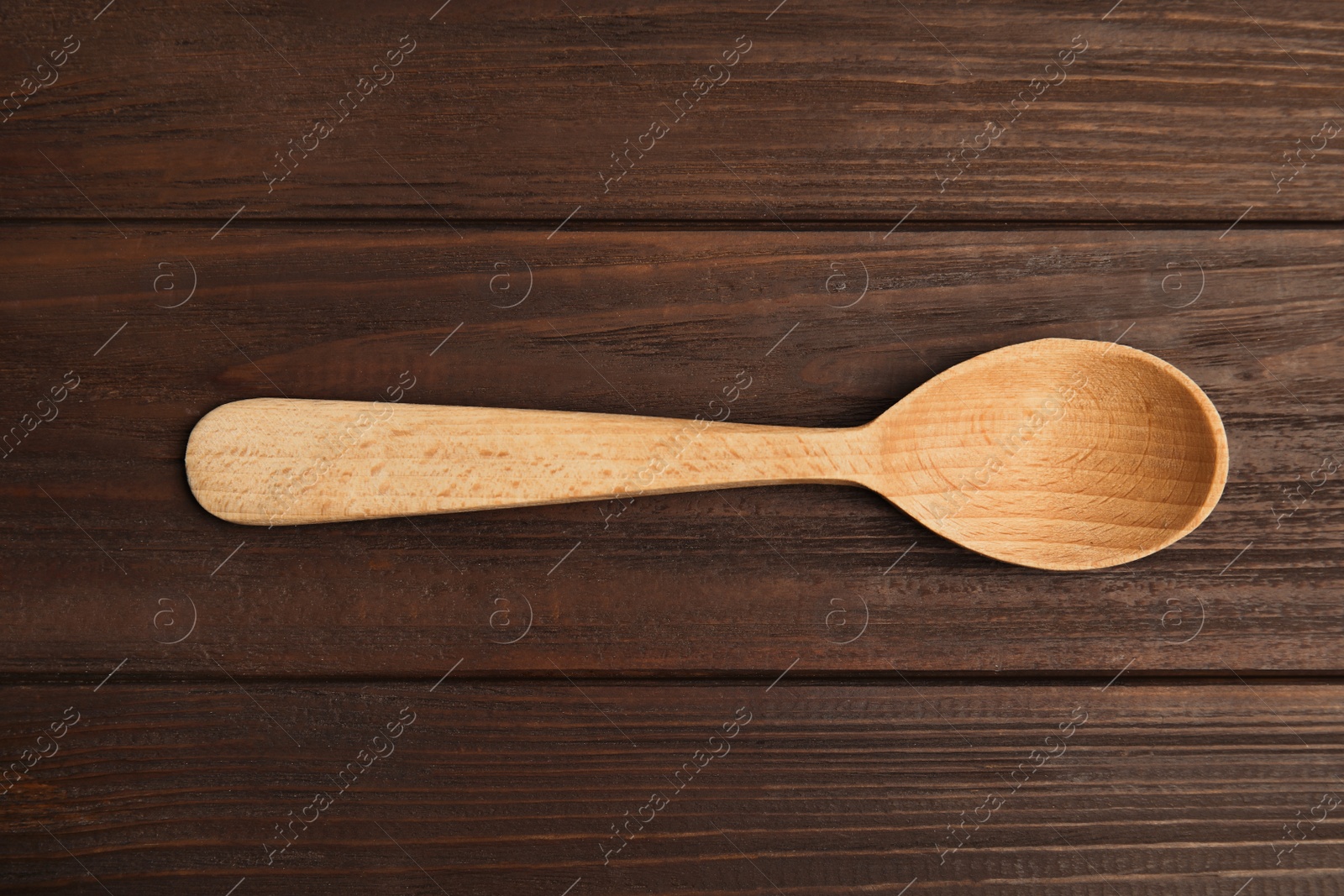 Photo of Handmade wooden spoon on rustic table, top view