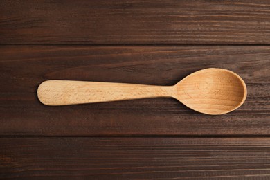 Photo of Handmade wooden spoon on rustic table, top view