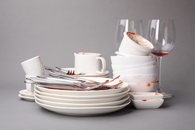 Photo of Set of dirty dishes on grey background