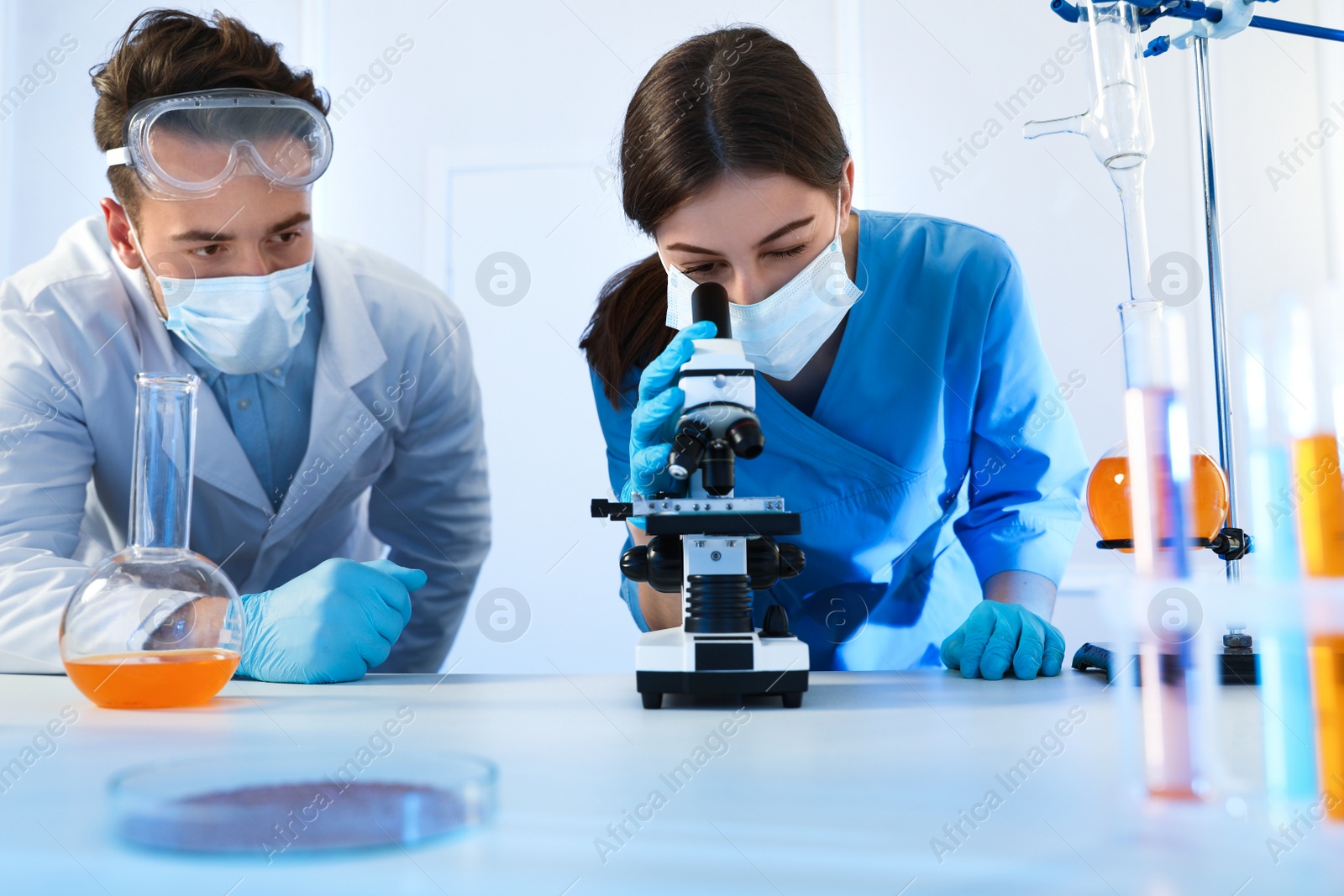 Photo of Scientists doing research and analysis with microscope in laboratory