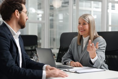 Lawyer working with client at table in office