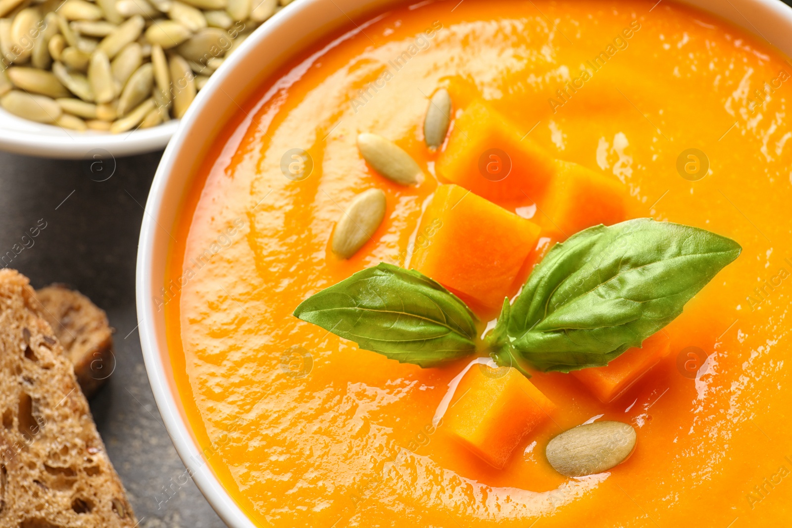 Photo of Bowl with tasty pumpkin soup, closeup view