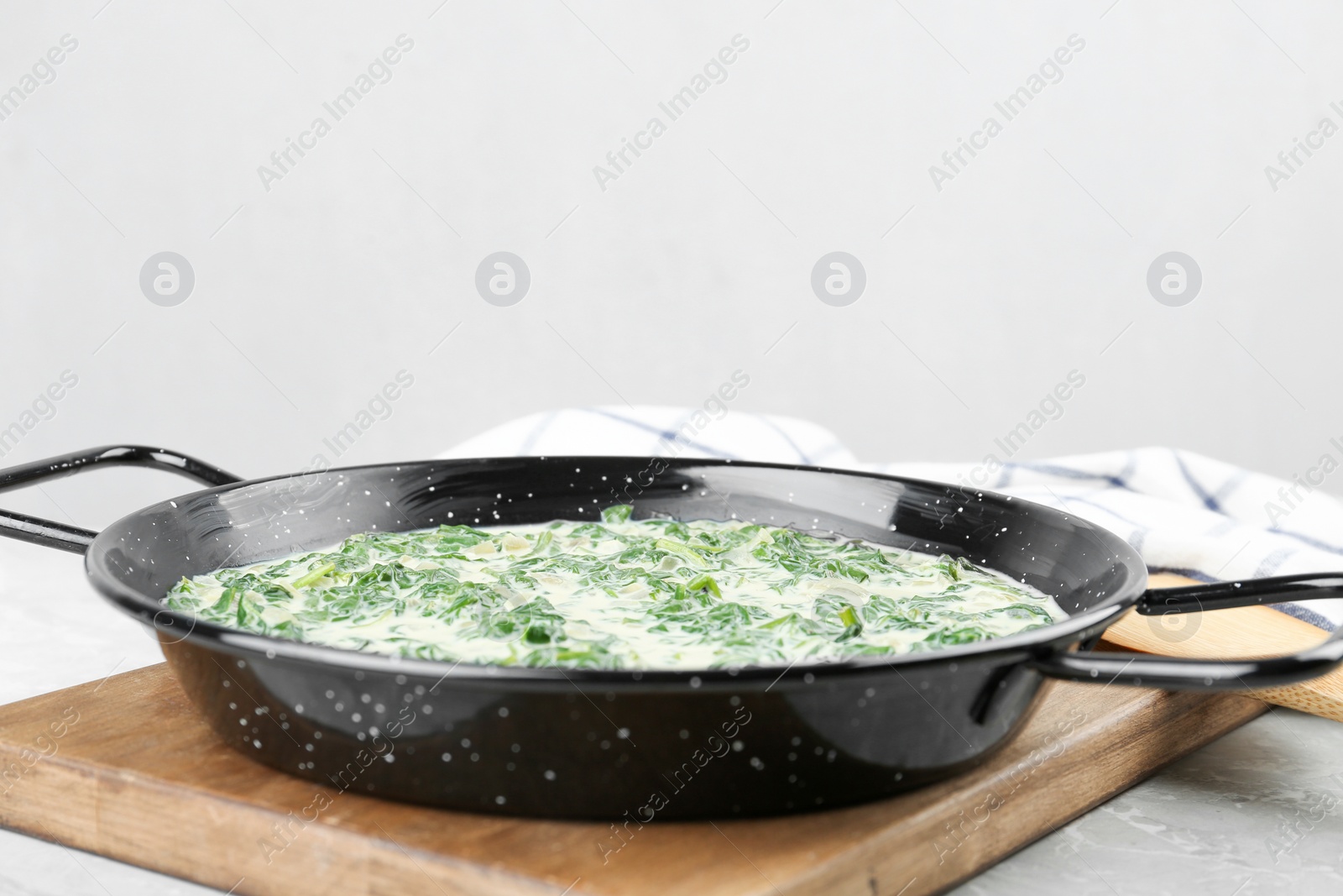 Photo of Tasty spinach dip on grey marble table