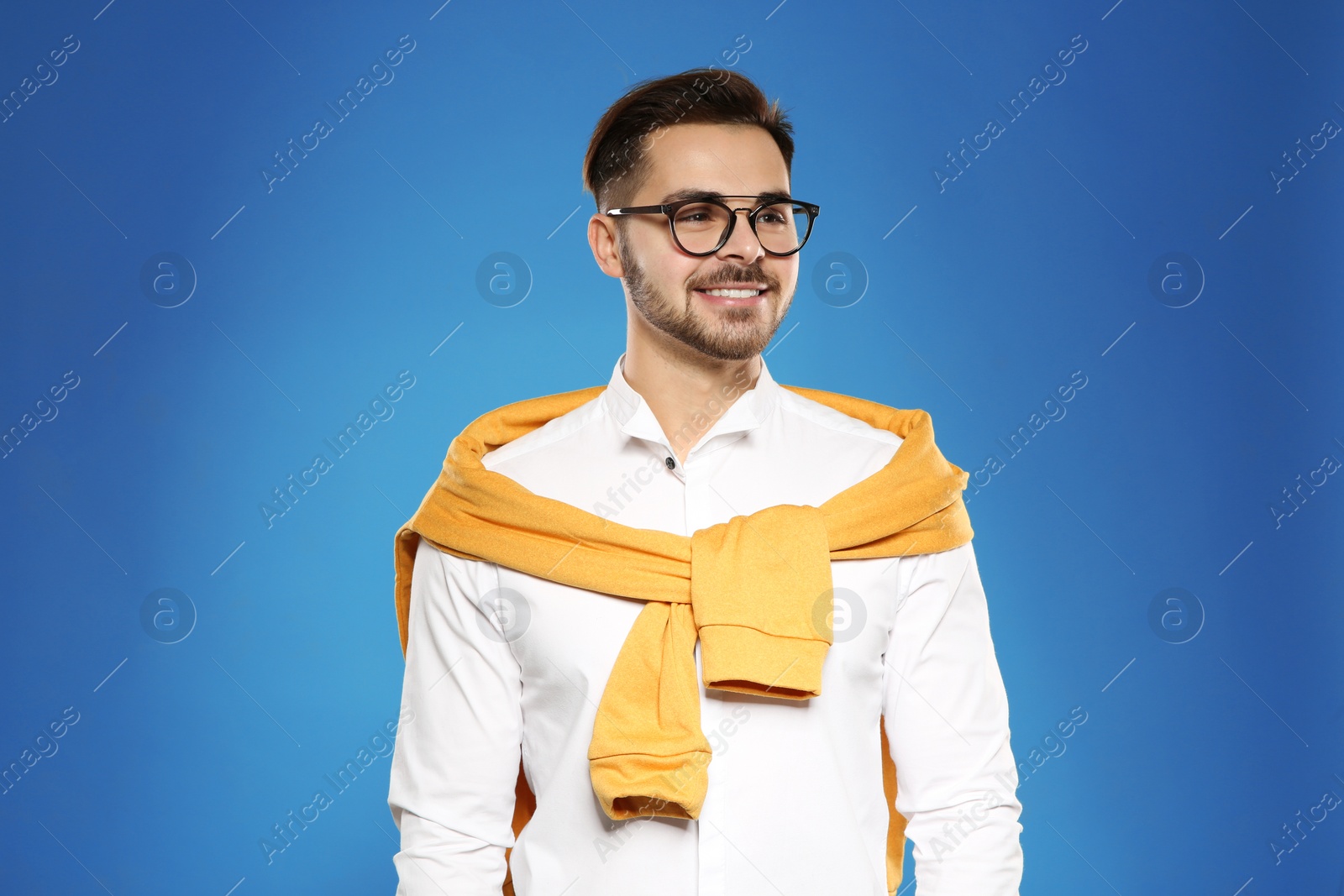 Photo of Portrait of handsome young man with glasses on color background