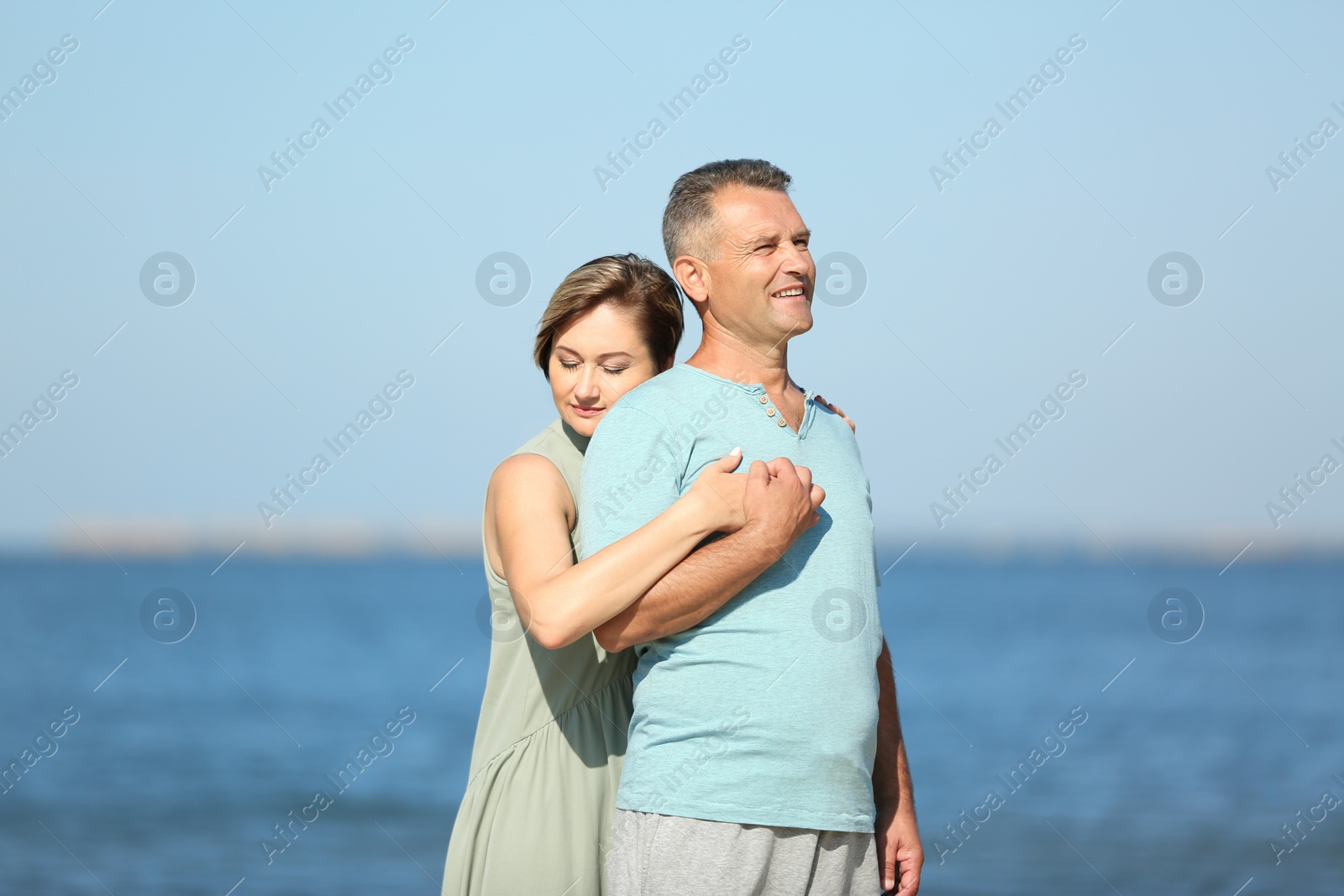 Photo of Happy mature couple at beach on sunny day