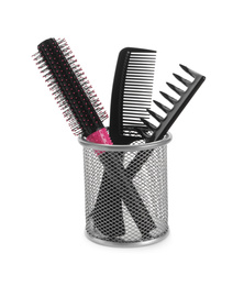 Photo of New modern hair brush and combs in metal holder isolated on white