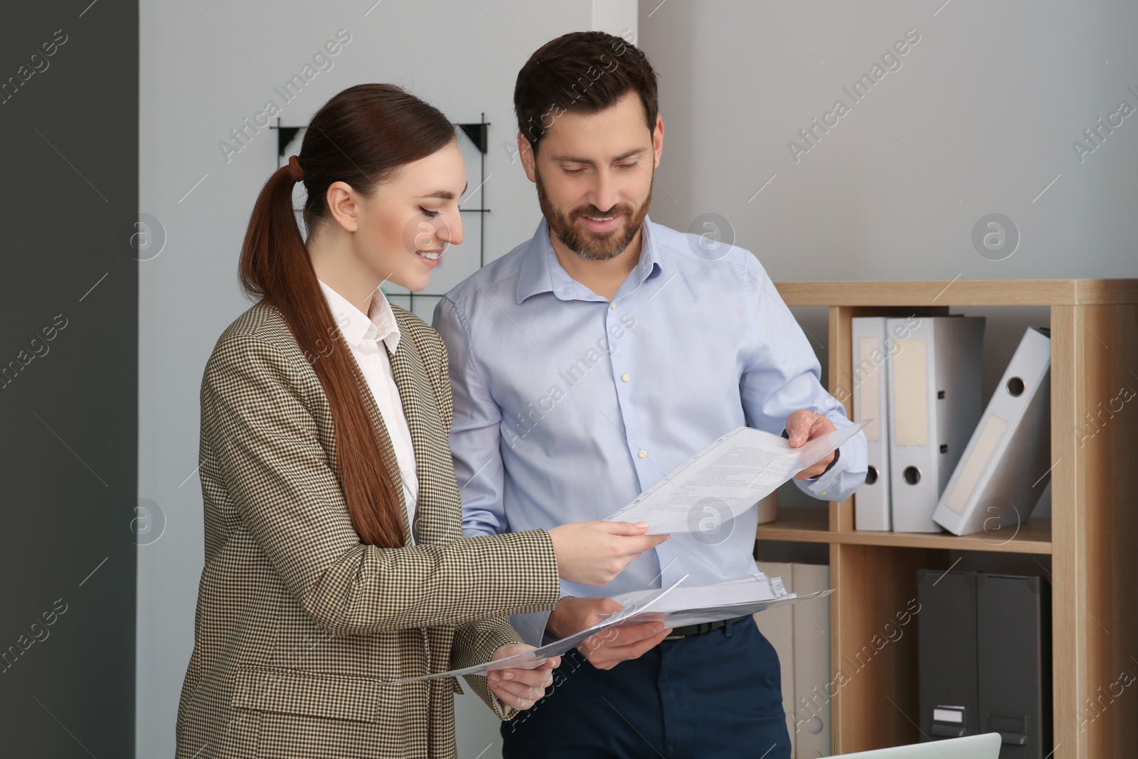 Photo of Businesspeople working together with documents in office