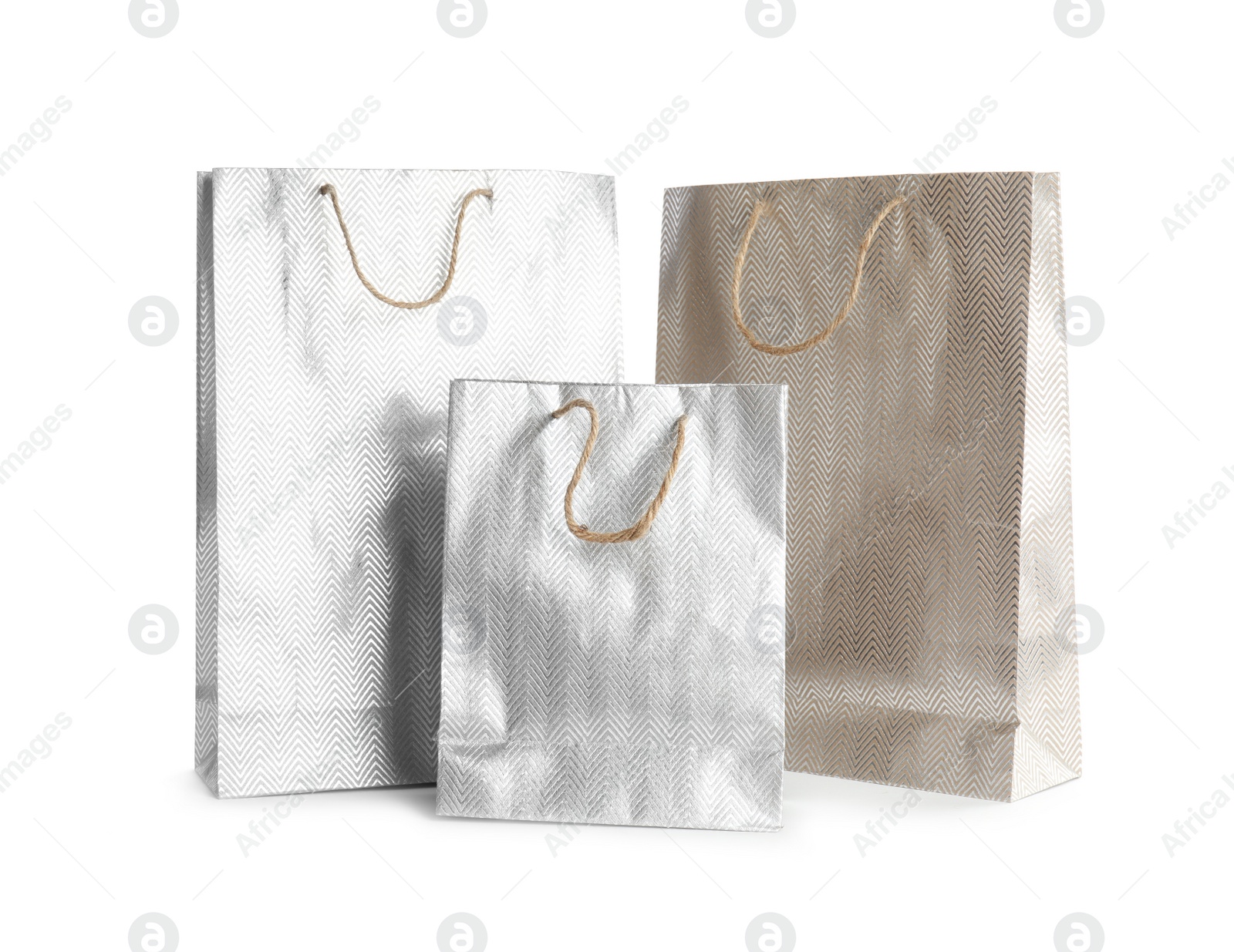 Photo of Silver paper shopping bags isolated on white. Space for design