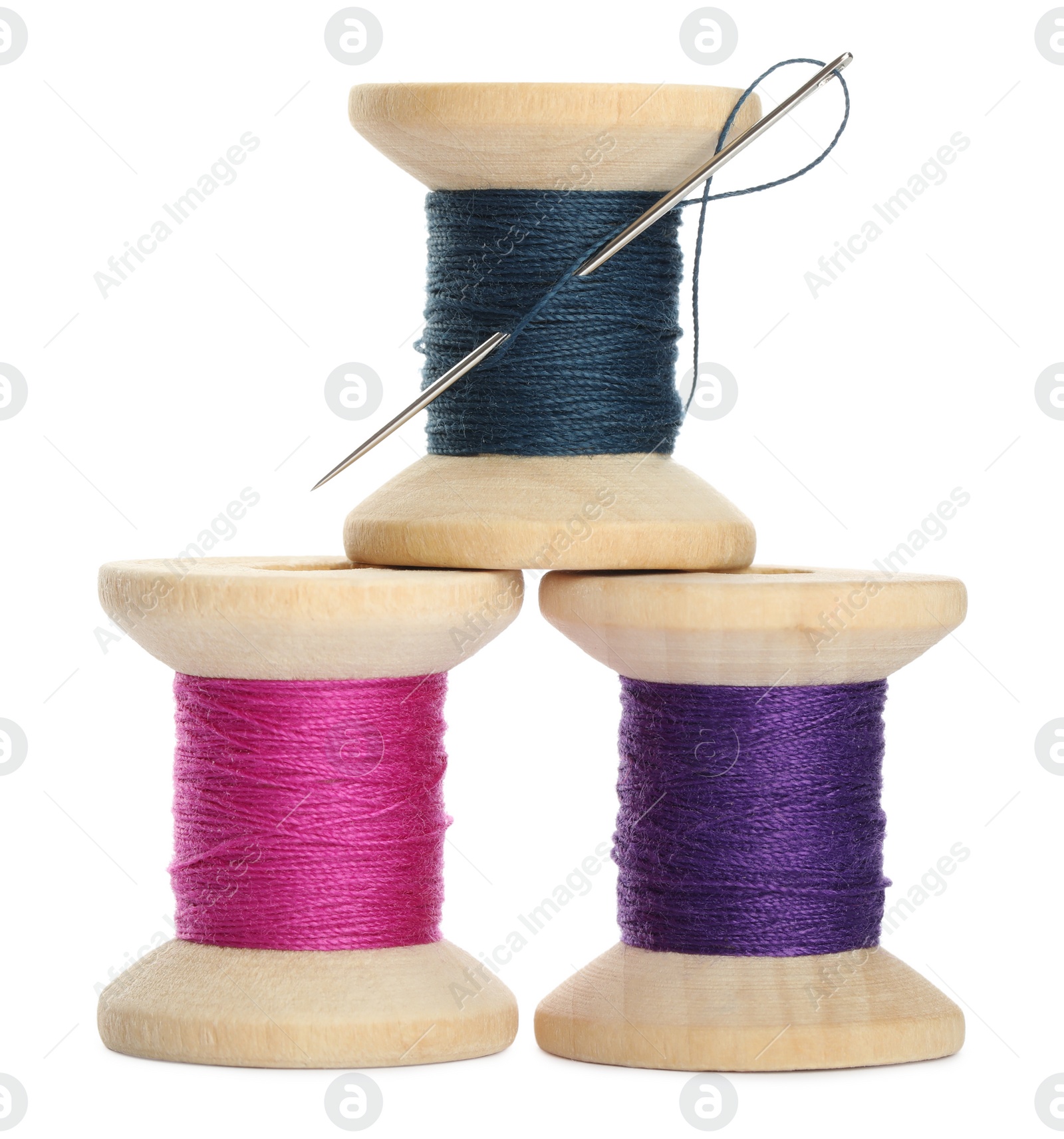 Photo of Different colorful sewing threads with needle on white background