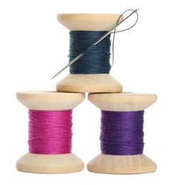 Different colorful sewing threads with needle on white background